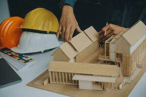 Construction and structure concept of Engineer or architect meeting for project working with partner and engineering tools on model building and blueprint in working site, contract for both companies. photo