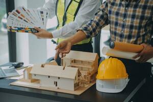 Construction and structure concept of Engineer or architect meeting for project working with partner and engineering tools on model building and blueprint in working site, contract for both companies. photo