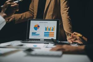 Financial analysts analyze business financial reports on a digital tablet planning investment project during a discussion at a meeting of corporate showing the results of their successful teamwork. photo