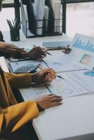 Financial analysts analyze business financial reports on a digital tablet planning investment project during a discussion at a meeting of corporate showing the results of their successful teamwork. photo