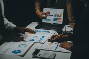 Financial analysts analyze business financial reports on a digital tablet planning investment project during a discussion at a meeting of corporate showing the results of their successful teamwork. photo