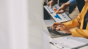 Close up of Business team analyzing income charts and graphs with modern laptop computer. Business analysis and strategy concept. photo