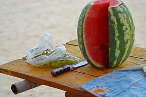 Cut watermelon with grapes on the table photo