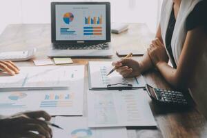Close up of Business team analyzing income charts and graphs with modern laptop computer. Business analysis and strategy concept. photo