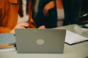 Asian businesswoman working on laptop computer Look for job online, freelance looking and typing on notebook on table, lifestyle of woman studying online photo