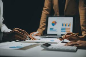 Financial analysts analyze business financial reports on a digital tablet planning investment project during a discussion at a meeting of corporate showing the results of their successful teamwork. photo