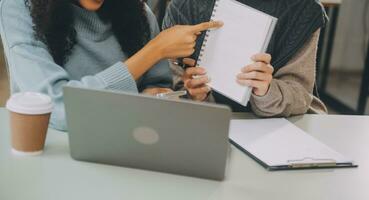 Asian businesswoman working on laptop computer Look for job online, freelance looking and typing on notebook on table, lifestyle of woman studying online photo