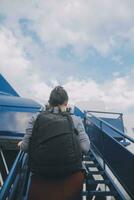 Happy attractive asian woman traveler with backpack at the modern airport terminal, copy space, Tourist journey trip concept photo