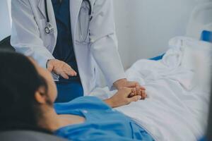 Happy senior woman visiting doctor, getting optimistic news after medical checkup, therapy. Therapist holding hand of old patient, giving hope, support, congratulating on goor treatment result photo