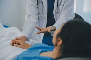 Happy senior woman visiting doctor, getting optimistic news after medical checkup, therapy. Therapist holding hand of old patient, giving hope, support, congratulating on goor treatment result photo