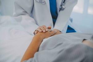 Doctor taking care, help and encourage Asian elder senior woman patient in clinic hospital. photo