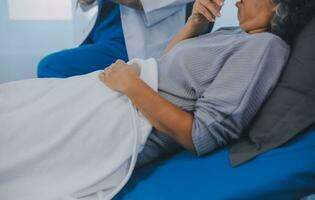 Female doctor administers specialized medical treatment to a patient in a hospital room. The procedure includes fluid therapy and injections to support the patient's health diagnosis and recovery. photo