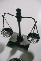 image of judge's hammer, scales lady of justice, law book, laptop computer and contract documents with pen concept of law and justice. photo