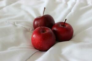 White Fabric And Three Whole Red Apples On It Detailed Stock Photo