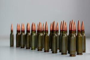 Full jacket bullets for assault rifle in a row defocused on the edge stock photo