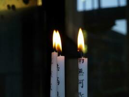 Three Burning Wax Candles In Japanese Style photo