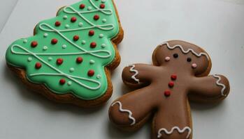 Shortbread Cookies In Shape Of Funny Man And Pine Tree On White Surface Angle View photo