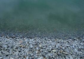 Small Gravel And Water Of Pond Bank photo