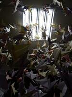 Handmade colorful paper craft cranes on a strings photo