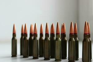 Mild steel core ammunition for automatic rifle lined up on a white background with soft focus stock photo