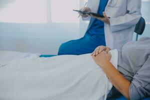 Female doctor administers specialized medical treatment to a patient in a hospital room. The procedure includes fluid therapy and injections to support the patient's health diagnosis and recovery. photo