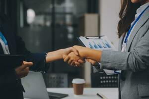 Real estate broker agent and customer shaking hands after signing contract documents for realty purchase, Bank employees congratulate, Concept mortgage loan approval. photo