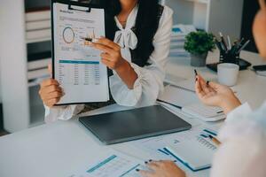 Business team collaboration discussing working analyzing with financial data and marketing growth report graph in team, presentation and brainstorming to strategy planning making profit of company. photo