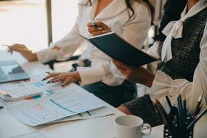 Business team collaboration discussing working analyzing with financial data and marketing growth report graph in team, presentation and brainstorming to strategy planning making profit of company. photo
