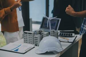 Electrical engineer with businessman discussing new project installation solar cell panel on the roof of building. Alternative energy concept. photo