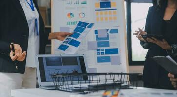 Close up ux developer and ui designer use augmented reality brainstorming about mobile app interface wireframe design on desk at modern office.Creative digital development agency photo