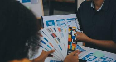 Close up ux developer and ui designer use augmented reality brainstorming about mobile app interface wireframe design on desk at modern office.Creative digital development agency photo