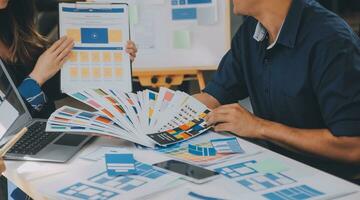 Close up ux developer and ui designer use augmented reality brainstorming about mobile app interface wireframe design on desk at modern office.Creative digital development agency photo