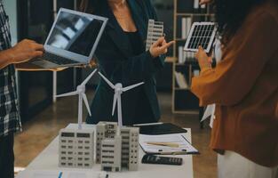 Electrical engineer with businessman discussing new project installation solar cell panel on the roof of building. Alternative energy concept. photo