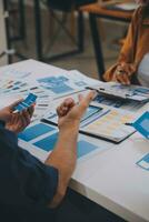 Close up ux developer and ui designer use augmented reality brainstorming about mobile app interface wireframe design on desk at modern office.Creative digital development agency photo