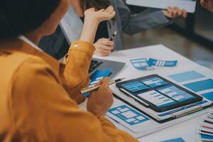 Close up ux developer and ui designer use augmented reality brainstorming about mobile app interface wireframe design on desk at modern office.Creative digital development agency photo