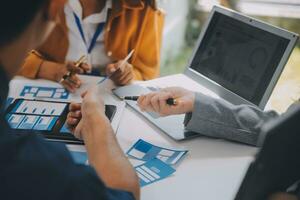 Close up ux developer and ui designer use augmented reality brainstorming about mobile app interface wireframe design on desk at modern office.Creative digital development agency photo