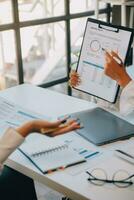 Business team collaboration discussing working analyzing with financial data and marketing growth report graph in team, presentation and brainstorming to strategy planning making profit of company. photo