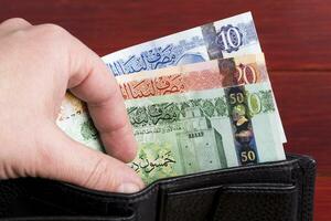 Libyan dinar in the black wallet photo