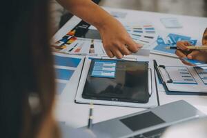 Close up ux developer and ui designer use augmented reality brainstorming about mobile app interface wireframe design on desk at modern office.Creative digital development agency photo