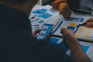 Close up ux developer and ui designer use augmented reality brainstorming about mobile app interface wireframe design on desk at modern office.Creative digital development agency photo