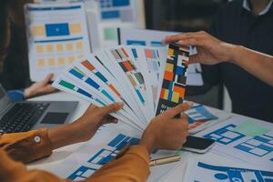 Close up ux developer and ui designer use augmented reality brainstorming about mobile app interface wireframe design on desk at modern office.Creative digital development agency photo