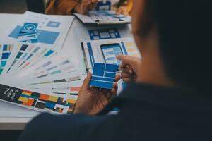 Close up ux developer and ui designer use augmented reality brainstorming about mobile app interface wireframe design on desk at modern office.Creative digital development agency photo