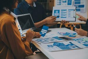 Close up ux developer and ui designer use augmented reality brainstorming about mobile app interface wireframe design on desk at modern office.Creative digital development agency photo