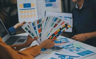 Close up ux developer and ui designer use augmented reality brainstorming about mobile app interface wireframe design on desk at modern office.Creative digital development agency photo