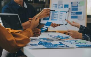 Close up ux developer and ui designer use augmented reality brainstorming about mobile app interface wireframe design on desk at modern office.Creative digital development agency photo