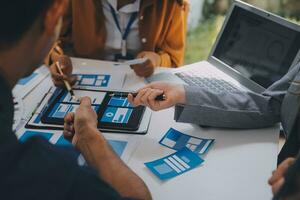 Close up ux developer and ui designer use augmented reality brainstorming about mobile app interface wireframe design on desk at modern office.Creative digital development agency photo