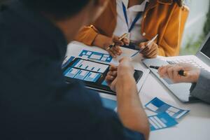 Close up ux developer and ui designer use augmented reality brainstorming about mobile app interface wireframe design on desk at modern office.Creative digital development agency photo