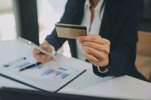 Women holding credit card and using smartphones at home.Online shopping, internet banking, store online, payment, spending money, e-commerce payment at the store, credit card, concept photo