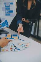 Close up ux developer and ui designer use augmented reality brainstorming about mobile app interface wireframe design on desk at modern office.Creative digital development agency photo