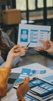 Close up ux developer and ui designer use augmented reality brainstorming about mobile app interface wireframe design on desk at modern office.Creative digital development agency photo